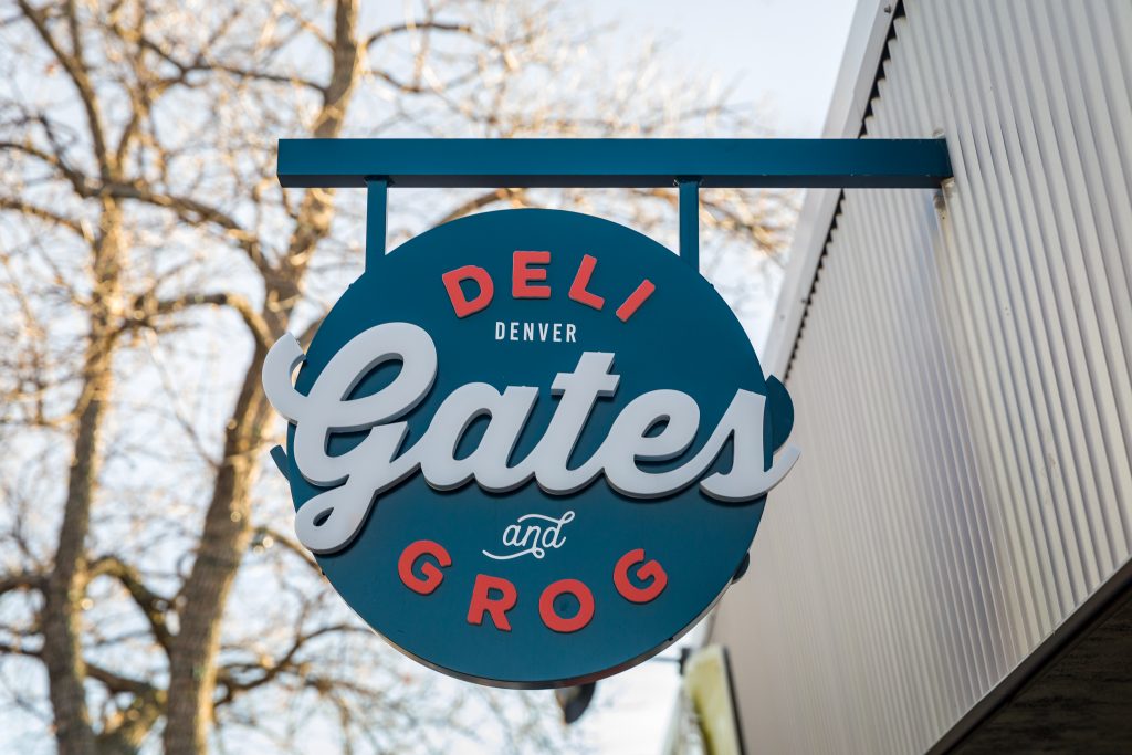 Gates Deli projecting blade sign during the day in Denver