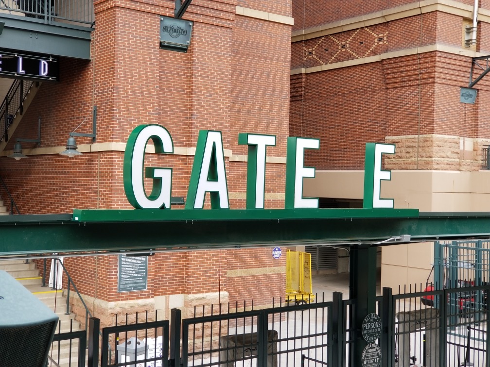 Exterior channel letters mounted on steel frame at Gate E entrance of Coors Field in Denver