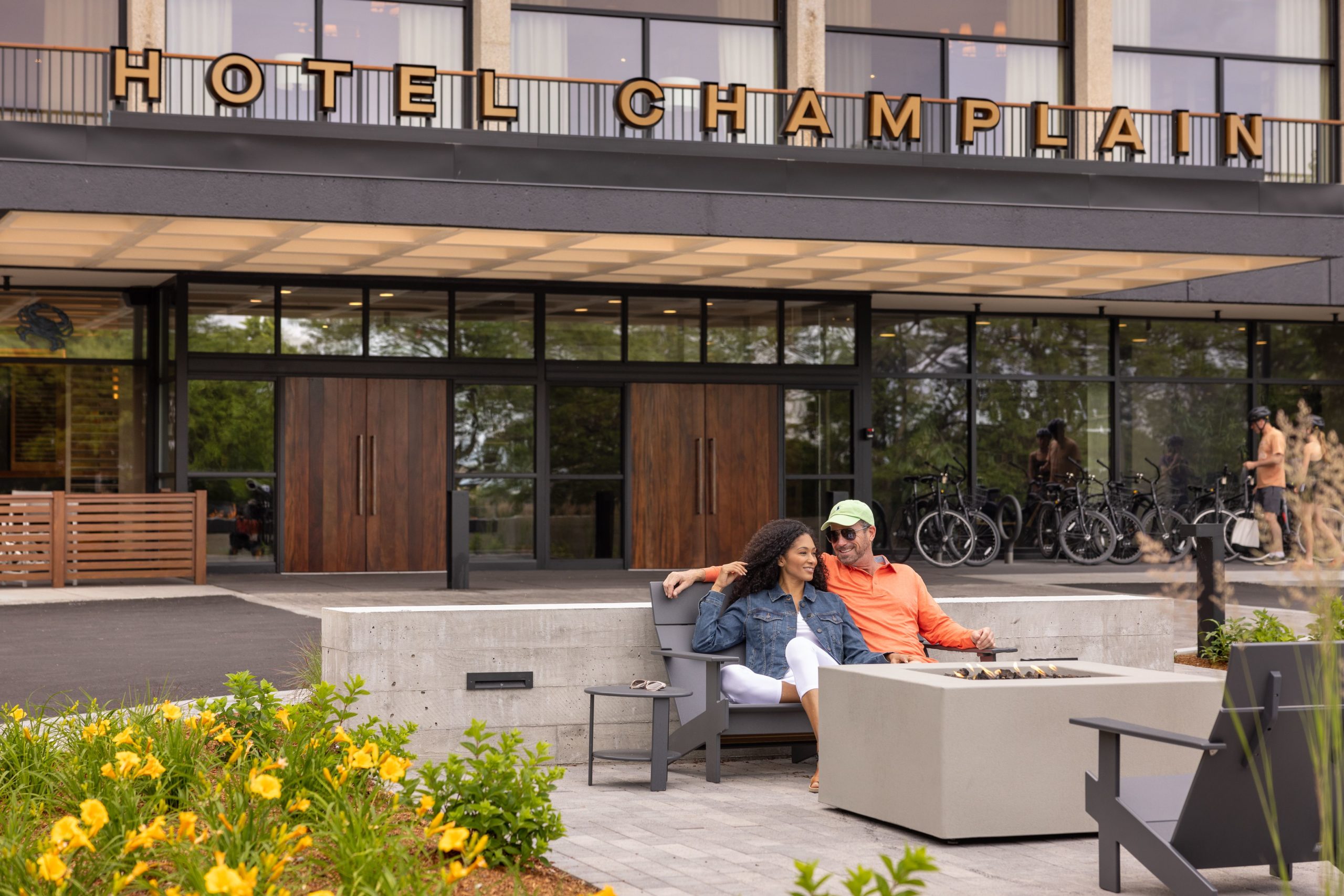 people relaxing at the entrance in front of exeterior sign at hotel champlain