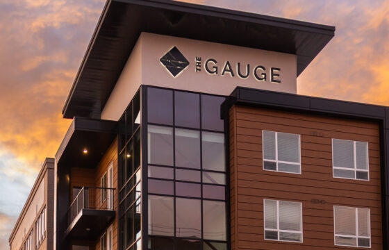 close view of illuminated exterior building letters on the gauge apartments in salt lake city