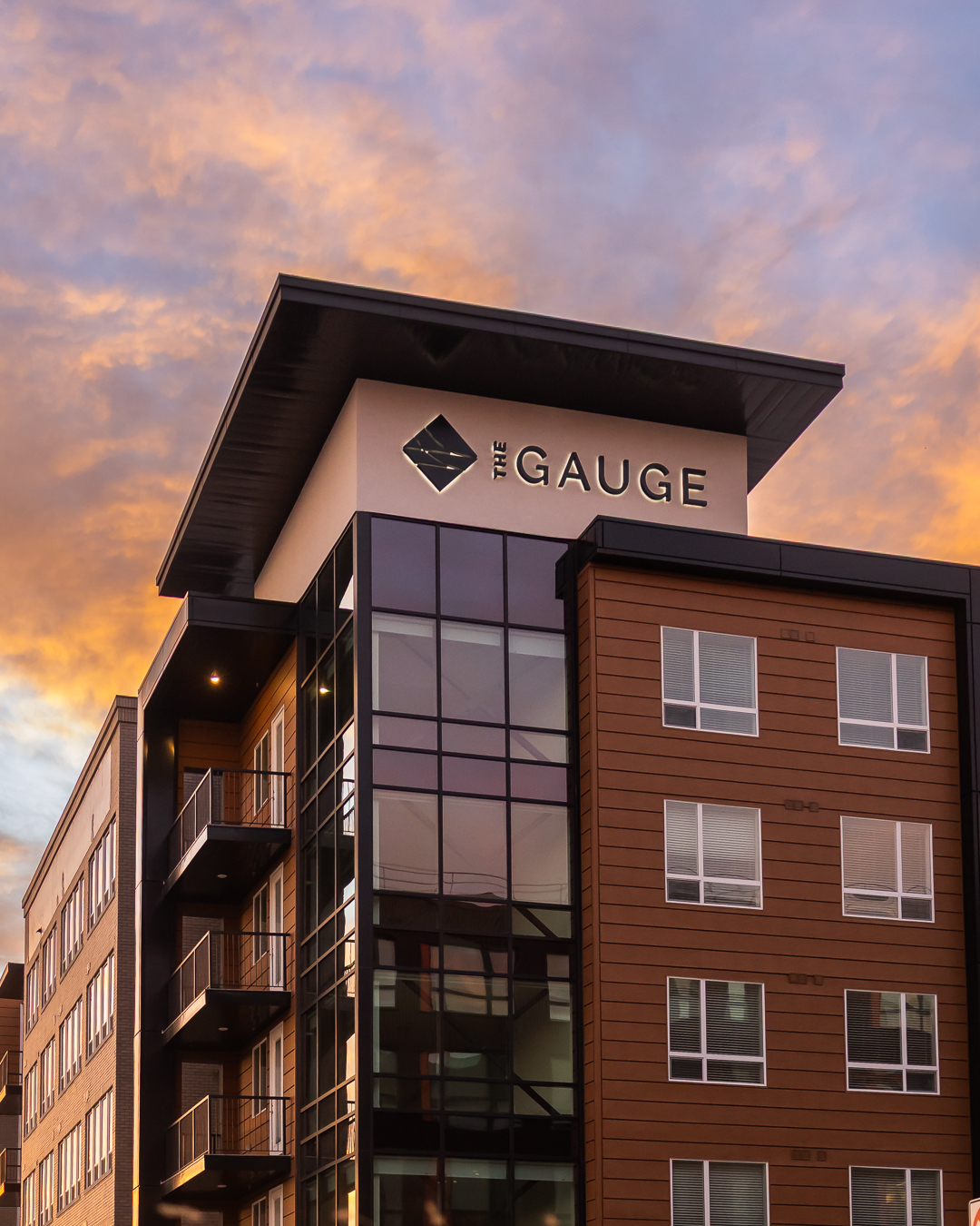 close view of illuminated exterior building letters on the gauge apartments in salt lake city