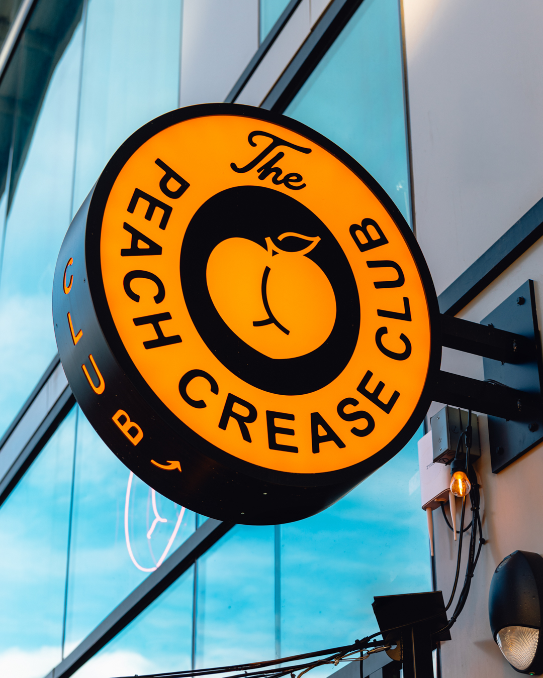 custom bar signage installation for Peach Crease Club near Mission Ballroom daytime street view