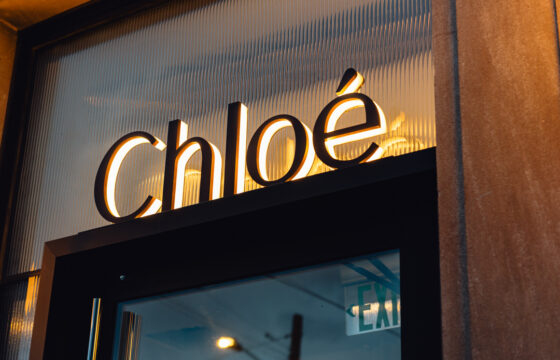 Close-up of custom reverse halo-lit Chloé letters with warm LED illumination.