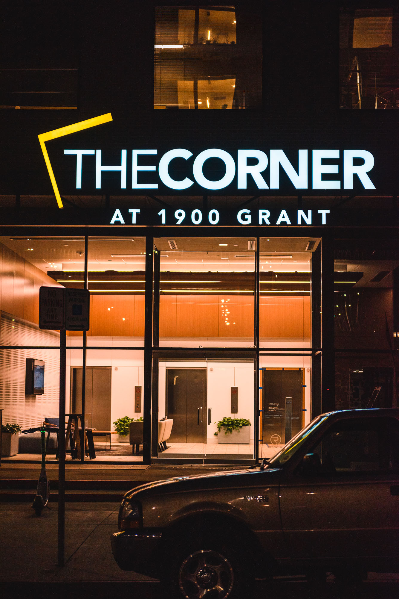 Custom illuminated building identification sign at The Corner at 1900 Grant apartment community in Denver.